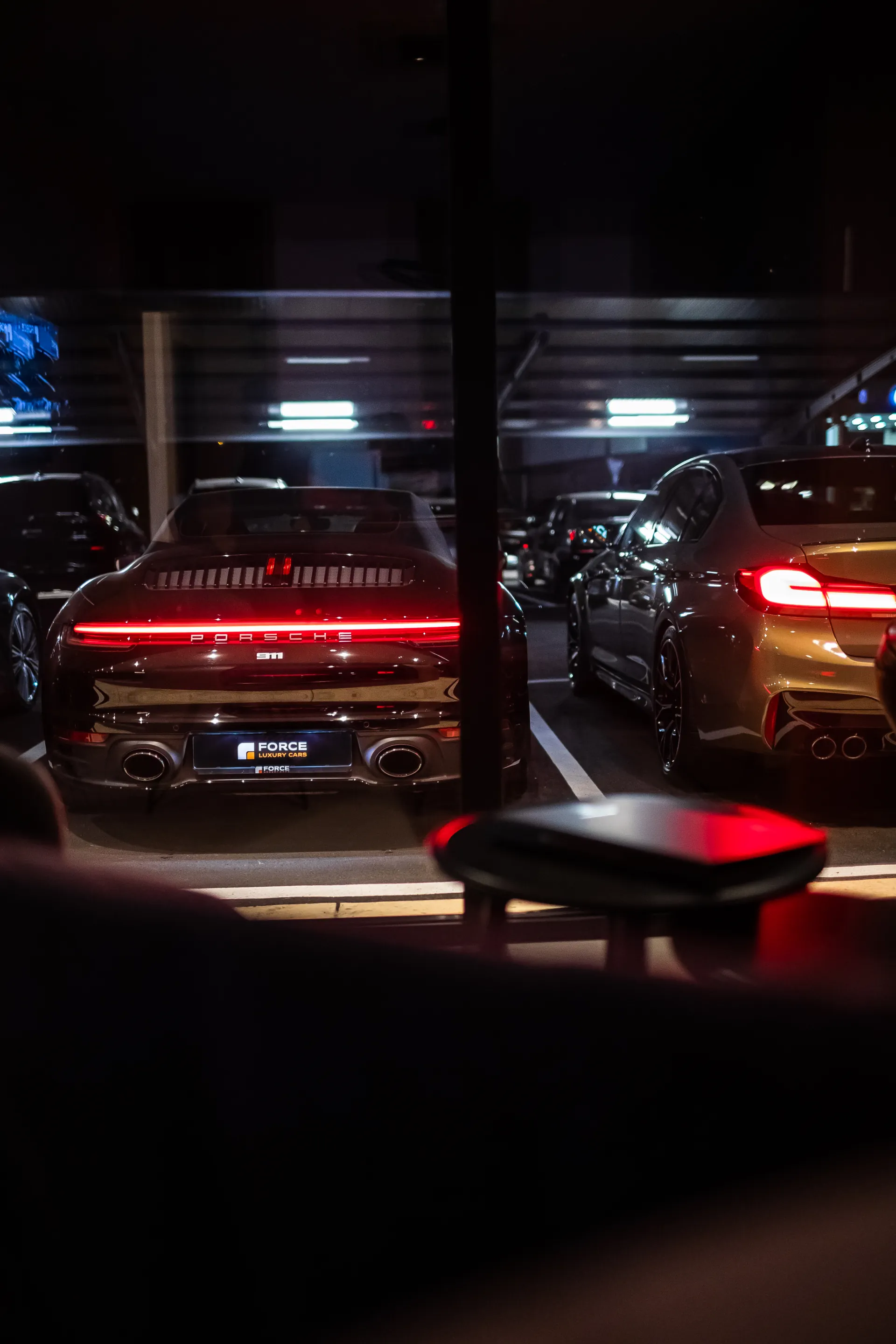 View of cars from inside of Force Luxury Cars office